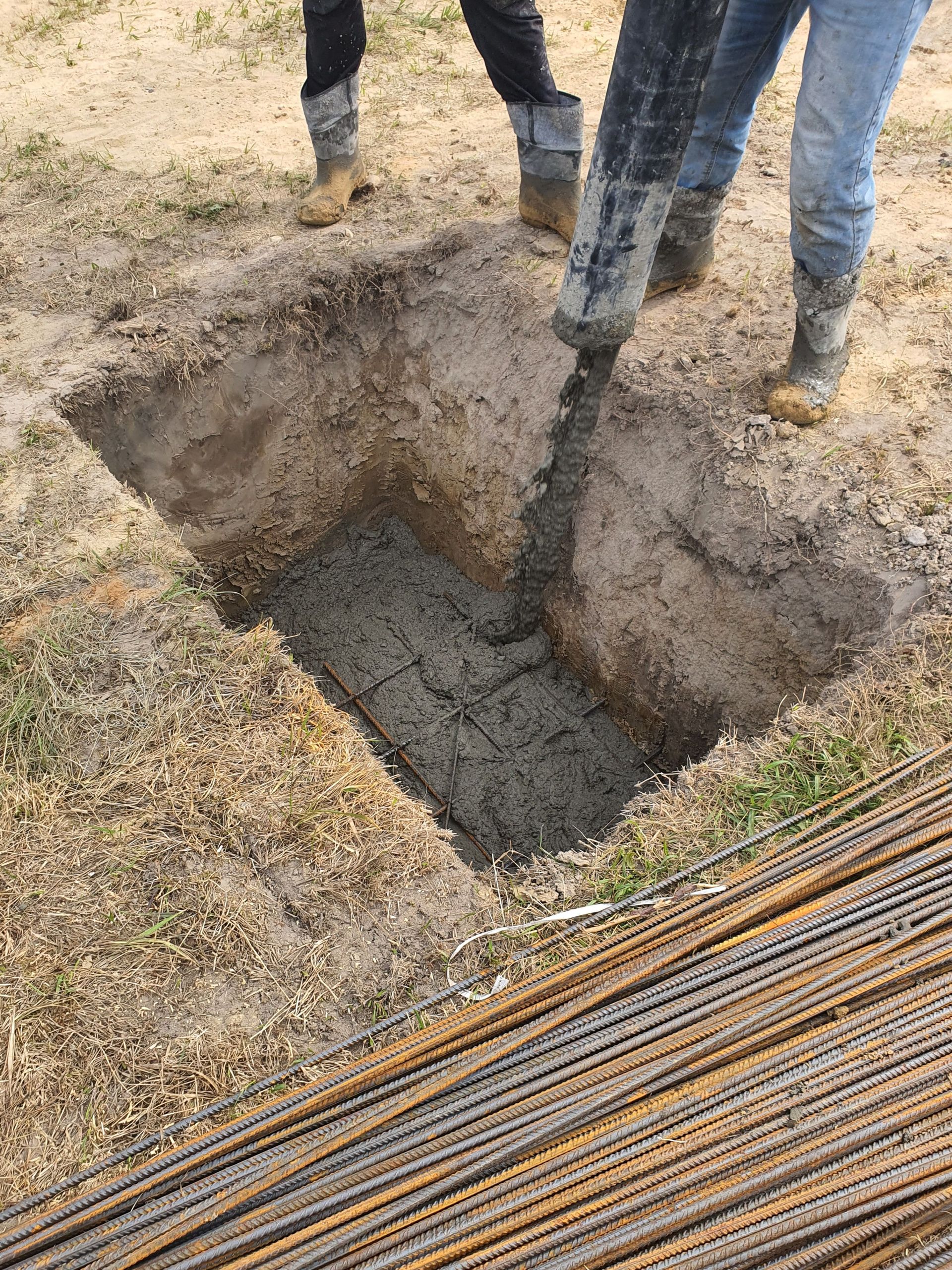 A detailed view of concrete pouring at a construction site in Miedniewice-Topola, Poland.